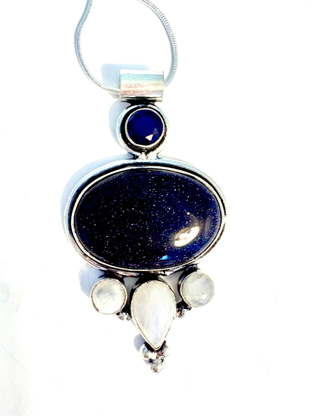 2 lunch, 925 marked ,Sunstone rainbow moonstone. and Tanzanite pendant.